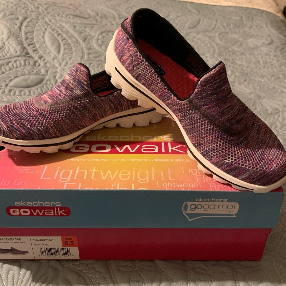 Like New Ladies, Purple, Slip on Skechers with white soles.